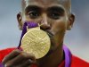 Britain's Mo Farah kisses his gold medal for the men's 5000m at the victory ceremony at the London 2012 Olympic Games