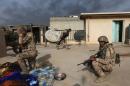 Iraqi soldiers take cover during clashes with Islamic State fighters in Mosul