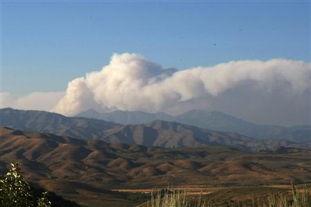Smoke from Trinity Ridge Fire rises over the mountains outside Pine