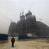 A man walks near a construction site in Beijing