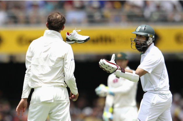 South Africa's Amla catches the shoe of teammate Petersen, after Petersen missed it while completing his run against Australia during the first cricket test match at the Gabba in Brisbane