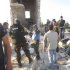 Members of the U.N. observer mission in Syria are seen between destroyed houses in Sermeen, near the northern city of Idlib,