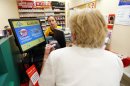 A clerk sells lottery tickets to an unidentified woman at Stop & Shop in South Brunswick, N.J. Thursday, Aug. 8, 2013. The supermarket is where one of the three winning Powerball tickets was sold. The two other locations are south Jersey and Minnesota. The jackpot is $448 million and is the third largest ever. (AP Photo/Rich Schultz)