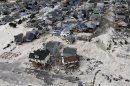 FILE - In this Oct. 31, 2012 file photo, a view from the air shows the destroyed homes left in the wake of Superstorm Sandy in Seaside Heights, N.J. New Jersey got the brunt of Sandy, which made landfall in the state and killed six people. A presidential task force charged with developing a strategy for rebuilding coastal areas damaged by Sandy will issue a report on Monday, Aug. 19, 2013, recommending 69 measures that might help insure that coastal areas aren't as vulnerable to future storms in an age of rising sea levels. (AP Photo/Mike Groll, File)