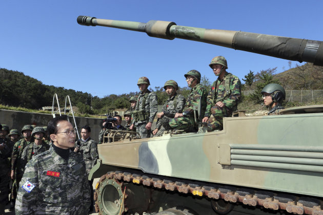 South Korean President Lee Myung-bak, left, visits marine base on Yeonpyeong Island near the Yellow Sea border with North Korea, South Korea, Thursday, Oct. 18, 2012. The island was bombarded in the North Korea's shelling attack in November 2010, leaving two South Korean Marines and two civilians dead.(AP Photo/Yonhap, Do Kwang-hwan) KOREA OUT