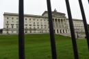 The Parliament Buildings at Stormont are seen behind railings, in Belfast