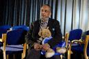 Abase Hussen, father of 15-year-old British girl Amira Abase who left her east London home on February 17 and flew to Istanbul, holds a bear that Amira gave to her mother during an interview at New Scotland Yard, central London on February 22, 2015