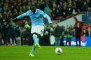Manchester City's midfielder and captain Yaya Toure scores the winning penalty in the shoot-out to help Manchester City win the English League Cup final football match between Liverpool and Manchester City in London on February 28, 2016