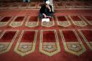 An Egyptian man reads from the Koran, Islam's holy book, inside Al-Azhar mosque in the old city of Cairo