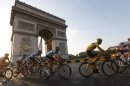 The pack of riders including leader's yellow jersey holder Froome cycles past the Arc de Triomphe during the final stage of the centenary Tour de France cycling race from Versailles to Paris Champs Elysees