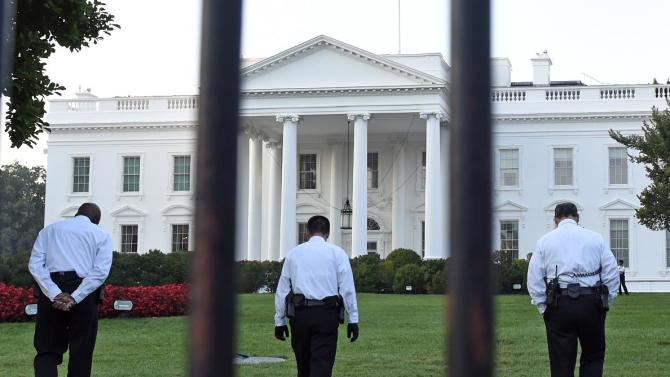 Uniformed Secret Service officers walk along the lawn on the North side of the White House in Washington, Saturday, Sept. 20, 2014. The Secret Service is coming under renewed scrutiny after a man scaled the White House fence and made it all the way through the front door before he was apprehended.  (AP Photo/Susan Walsh)