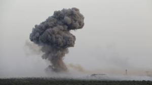 Smoke rises from Qarmeed camp after who Islamist rebel fighters said was a suicide bomber from al Qaeda&#39;s Nusra Front drove a truck packed with explosives into the compound and blew it up, in northwestern Idlib province