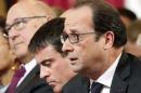French President Francois Hollande sits beside French Prime Minister Manuel Valls during the Environmental Conference at the Elysee Palace in Paris