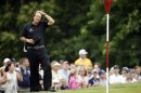 Phil Mickelson rubs his head before putting on the ninth hole during the fourth round of the U.S. Open golf tournament at Merion Golf Club, Sunday, June 16, 2013, in Ardmore, Pa. (AP Photo/Morry Gash)