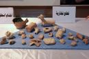 Looted artefacts recovered by the US military during a recent raid in Syria are returned to the Iraqi authorities on July 15, 2015 at the National Museum in Baghdad