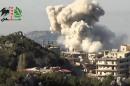 In this image taken from video obtained from the Shaam News Network, which has been authenticated based on its contents and other AP reporting, smoke rises from a building in Latakia, Syria, Wednesday, Jan. 8, 2014. (AP Photo/Shaam News Network via AP Video)