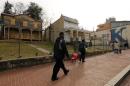 Pedestrians pass shuttered buildings in Ward 8 of Washington