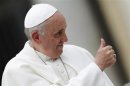 Pope Francis shows a thumbs-up sign as he arrives to lead his Wednesday general audience in Saint Peter's Square at the Vatican
