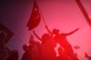 Demonstrators wave Turkish national flags on August 7, 2016 during a rally in Istanbul against the recent failed military coup
