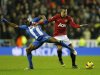 Wigan Athletic's Figueroa challenges Manchester United's Van Persie during their English Premier League soccer match at The DW Stadium in Wigan