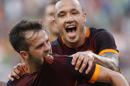 Roma's Miralem Pjanic, left, celebrates with teammate Radja Nainggolan after scoring on a free kick during a Serie A soccer match between Roma and Juventus, at Rome's Olympic stadium, Sunday, Aug. 30, 2015. (AP Photo/Riccardo De Luca)