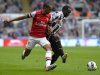 Newcastle's Mapou Yanga-Mbiwa challenges Arsenal's Theo Walcott during their English Premier League soccer match at St James' Park Newcastle, northern England