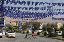 A street is decorated with blue flags, emblazoned with a candle, of Gorran on September 18, 2013 in Iraq's northern city of Sulaimaniyah