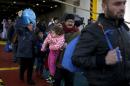 Refugees and migrants arrive aboard the passenger ferry Eleftherios Venizelos from the island of Lesbos at the port of Piraeus