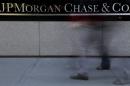 The JPMorgan Chase & Co. logo is displayed at their headquarters in New York, in this Monday, Oct. 21, 2013, file photo. A person close to the talks says the Justice Department and JPMorgan Chase & Co. have reached agreement on all issues in a $13 billion settlement of a civil inquiry into the company's sales of low-quality mortgage-backed securities that collapsed in value in the financial crisis. (AP Photo/Seth Wenig, File)