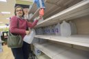 New Orleans resident Isabel Medina stocks up on bottled water at the Winn Dixie Supermarket on Tchoupitoulas Street due to a boil water advisory after water pressure dipped below 15 PSI on the east bank of Orleans Parish at the Orleans Parish Sewerage & Water Board in New Orleans , La., Sunday, March 3, 2013. (AP Photo/Matt Hinton)