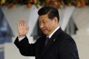 Chinese President Xi Jinping waves as he arrives at the World Forum on the second day of the two-day Nuclear Security Summit in The Hague on March 25, 2014