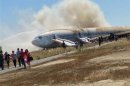 File picture shows passengers being evacuated from a Asiana Airlines Boeing 777 aircraft after a crash landing in San Francisco