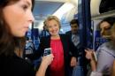 Clinton talks to reporters on her campaign plane in White Plains