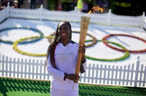 US tennis player Venus Williams holds the Olympic Torch at the Olympic tennis venue i