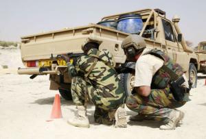 A U.S. soldier trains a Chadian soldier in a mock ambush …