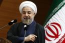 Rouhani addresses the audience during a meeting in Ankara