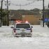A Port Authority Police SUV makes its way through flood waters covering roads leading toward Teterboro Airport in Teterboro