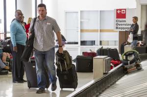 A passenger gets his luggage back at Los Angeles International …