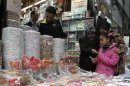 Girls buy candies at a shop in the old city of Damascus