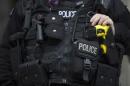 An armed police officer rests his hand on a taser outside the Ministry of Defence in London, Britain