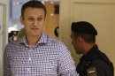 Russian protest leader Alexei Navalny walks into a courtroom to attend a hearing in Kirov