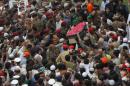 People try to touch the coffin of philanthropist Abdul Sattar Edhi during his funeral at the National Stadium in Karachi