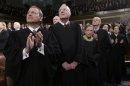 U.S. Supreme Court Justices applaud prior to President Obama's State of the Union speech on Capitol Hill in Washington