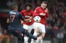 Manchester United's Wayne Rooney, right, blocks a shot by Bayern's Jerome Boateng during the Champions League quarterfinal first leg soccer match between Manchester United and Bayern Munich at Old Trafford Stadium, Manchester, England, Tuesday, April 1, 2014.(AP Photo/Jon Super)