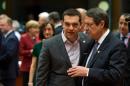 Greek Prime Minister Alexis Tsipras (L) speaks with Cyprus President Nicos Anastasiades (R) on March 19, 2015 at the Council of the European Union in Brussels