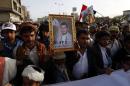 Supporters of the Shiite Huthi movement hold a portrait of Huthi leader, Abdulmalik al-Huthi, during a demonstration in Sanaa on April 10, 2015