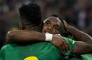 Cameroon's forward Samuel Eto'o celebrates with a teammate after scoring during the friendly football match Germany vs Cameroon in preparation for the FIFA World Cup 2014 on June 1, 2014 in Moenchengladbach, western Germany