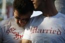Gay couple Ethan Collings and his spouse Stephen Abate hug as they celebrate their one-year wedding anniversary in West Hollywood