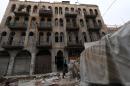 A rebel fighter monitors a street in the old city of Aleppo, Syria, on December 6, 2014