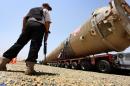 A section of an oil refinery is brought on a lorry to the Kawergosk Refinery, some 20 kilometres east of Arbil, the capital of the autonomous Kurdish region of northern Iraq, on July 14, 2014